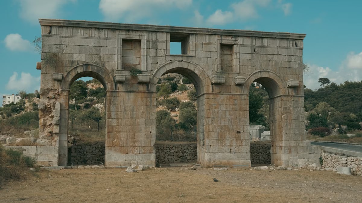 Roman arch ruins in Kaş, Antalya, Türkiye, showcasing ancient architecture.